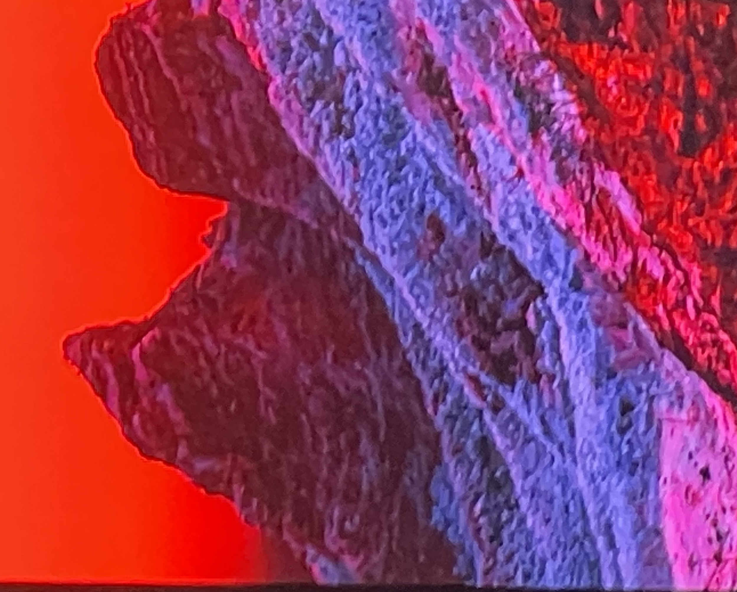 Twin mountain peaks against a vivid red sky