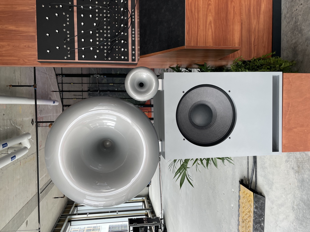 Large sculptural horn speakers and a woofer cabinet in the sound room