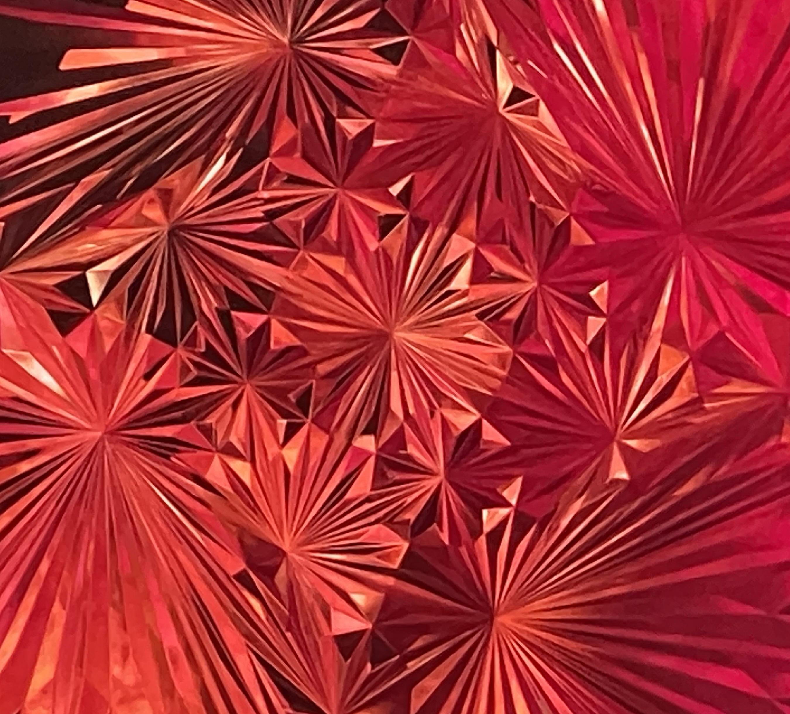 Field of red geometric starbursts radiating from points